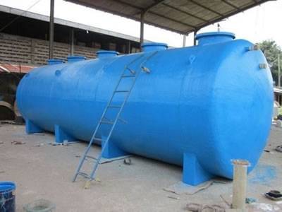 There is a FRP chemical storage tank in blue with a ladder.