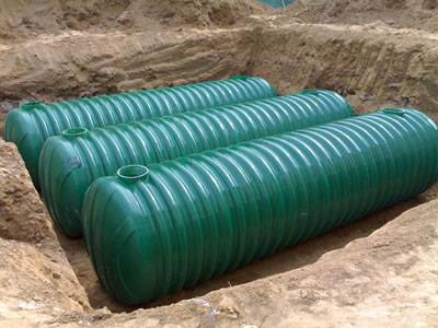 Three threaded FRP septic tanks with green coated are set underground.
