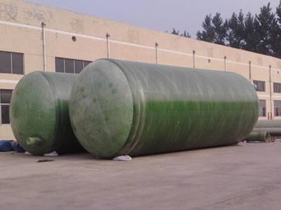 Two horizontal FRP tanks are placed on the ground.