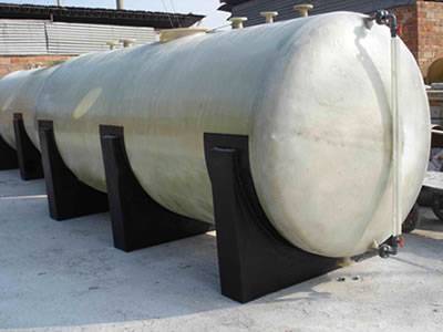 Horizontal FRP tanks are stored on the yard.